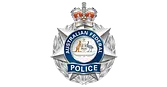 Australian Federal Police badge featuring a crown, a kangaroo and emu with a shield, and the words “Australian Federal Police” on a star-shaped silver emblem.