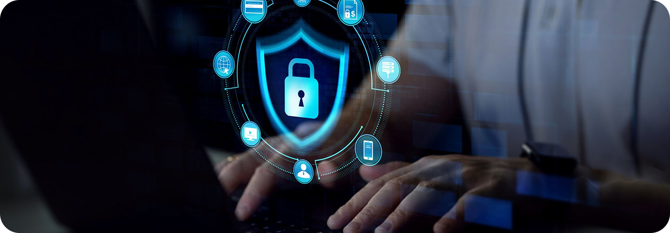 A person types on a laptop keyboard, with a digital overlay showing a glowing padlock icon inside a shield, surrounded by security and technology symbols, representing cybersecurity.